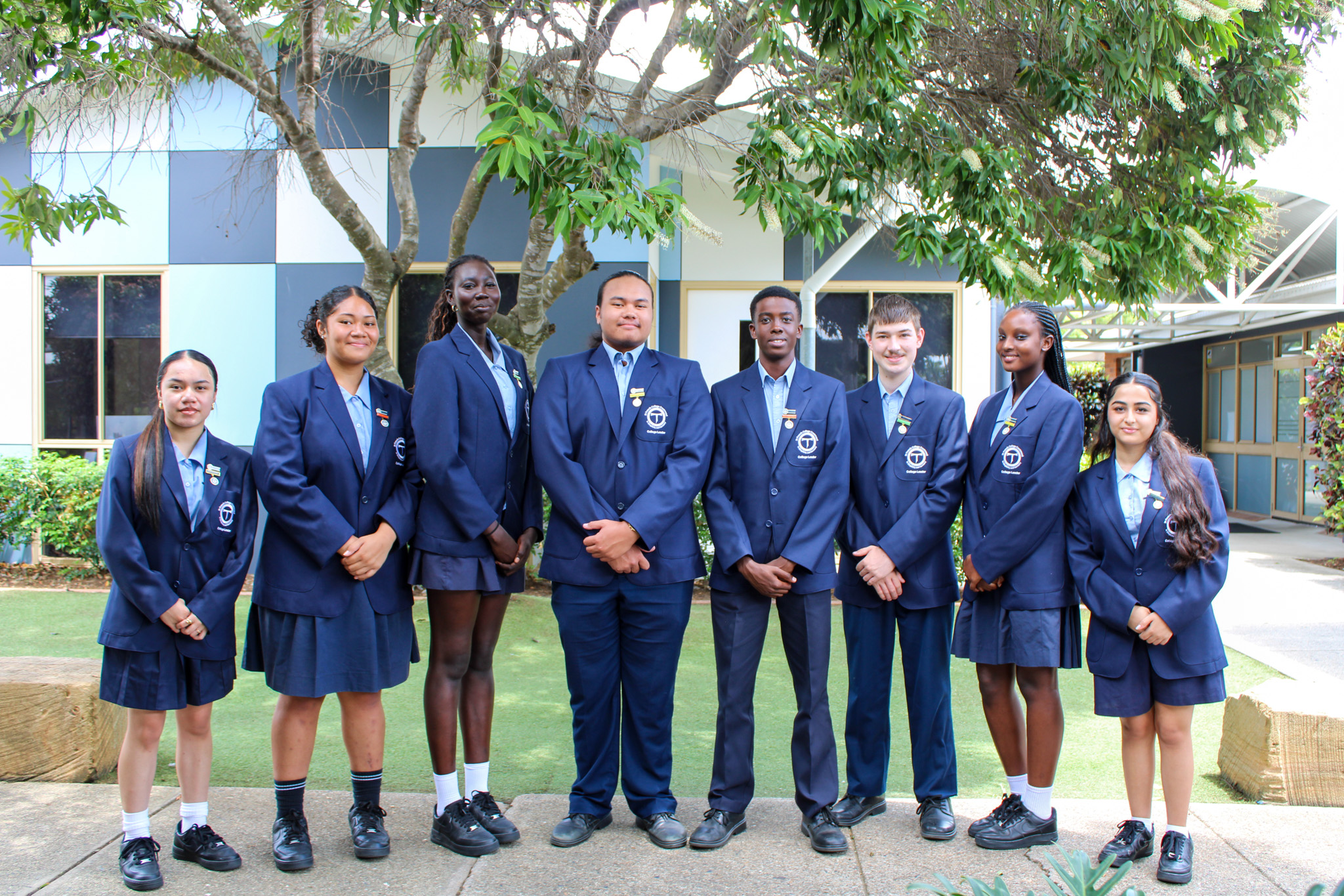 Student leadership group in school uniform standing together outdoors, representing diversity, leadership and community pride within the school